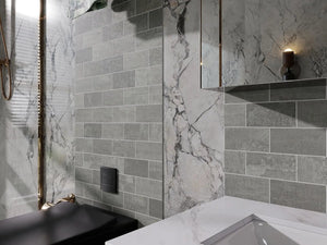 Modern bathroom with gray peel and stick tiled walls and a marble feature.