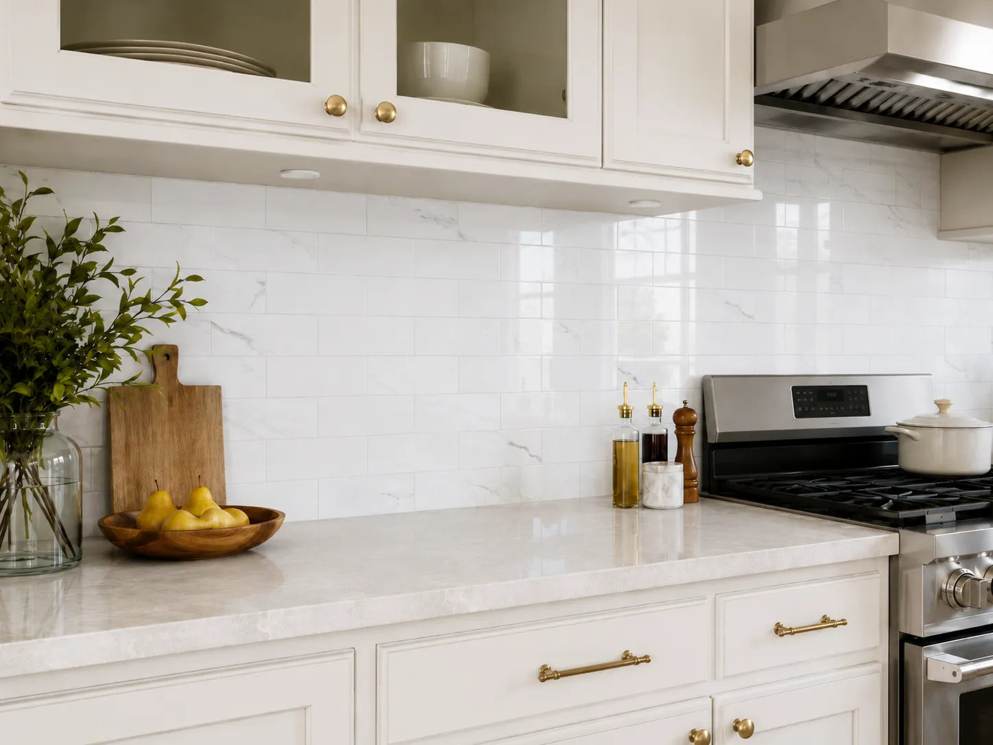 Carrara white marble peel and stick tile installed as kitchen backsplash behind stove – Colamo