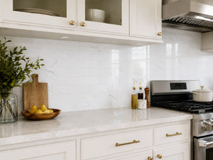 Carrara white marble peel and stick tile installed as kitchen backsplash behind stove – Colamo