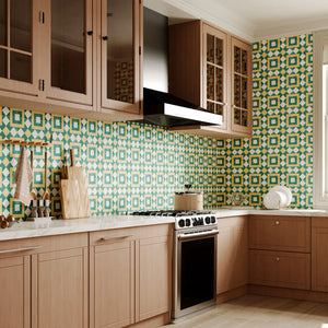 Modern retro kitchen featuring Colamo green and orange geometric peel and stick backsplash behind the stove, perfectly paired with natural wood cabinets.
