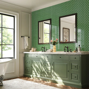 Colamo luxury green floral peel and stick wall tiles used as a bathroom vanity backsplash, featuring a vintage green cabinet and elegant mirrors.