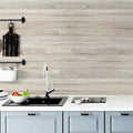 Kitchen with light peel and stick wood look backsplash and white countertop