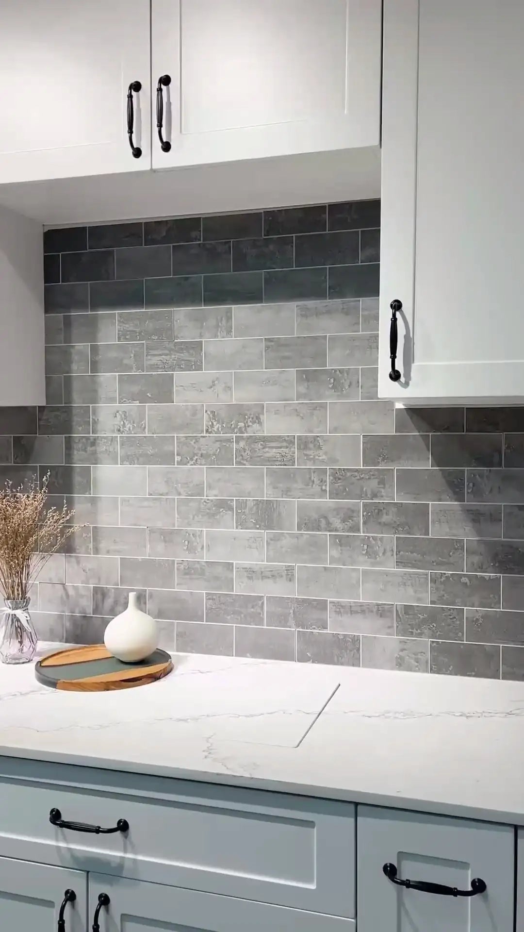 Kitchen with peel & stick gray tiled backsplash and white cabinets